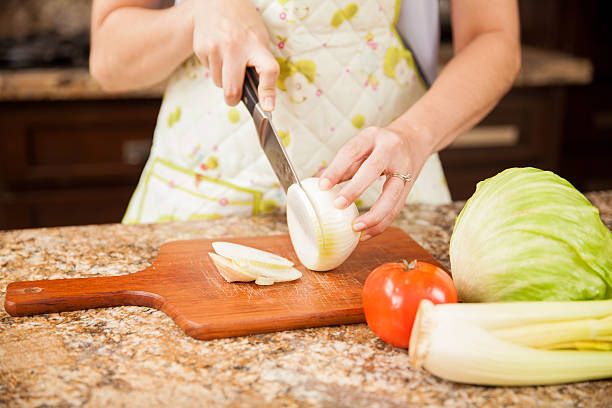 istock Cutting an onion in a chopping board 484466338