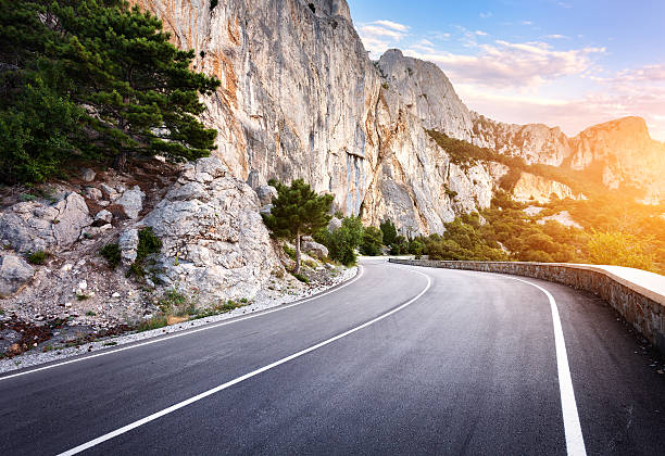 istock Asphalt road in summer forest at sunset. Crimean mountains 484467044