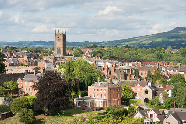 Ludlow Ludlow, UK - June 23, 2015: The town of Ludlow, in which the church tower is prominent, is photographed on a late afternoon in summer ludlow shropshire stock pictures, royalty-free photos & images