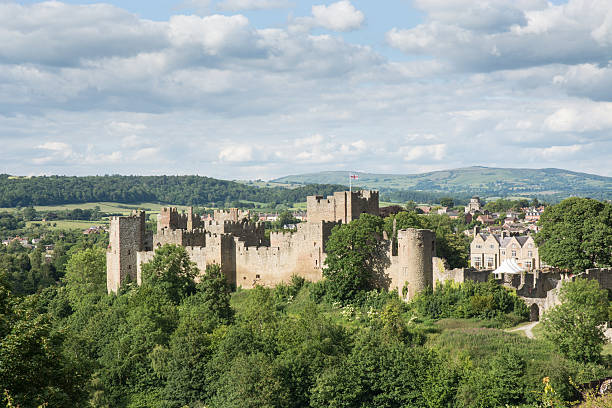 Ludlow Castle Ludlow, UK - June 23, 2015: Ludlow Castle stands on a wooded hill and is photographed here on a late afternoon in summer ludlow shropshire stock pictures, royalty-free photos & images