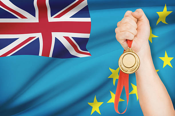 istock Medal in hand with flag on background - Tuvalu 484469105