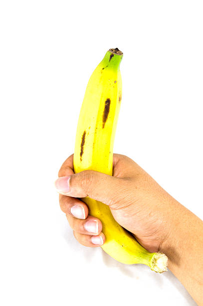 istock Banana in hand on white background 484469781
