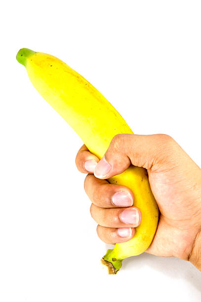 istock Banana in hand on white background 484469787