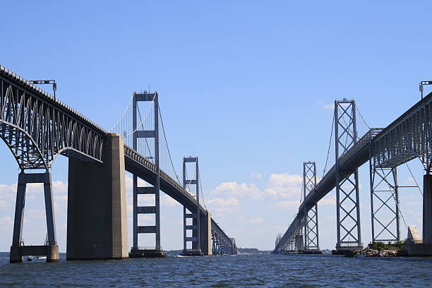 Chesapeake Bay Bridge on a Sunny Day Chesapeake Bay Bridge on a Sunny Day, View looking to the East from a Boat Under the Chesapeake Bay Bridge between the Spans, near Annapolis, Maryland, Sailing Capital of the World bay bridge stock pictures, royalty-free photos & images