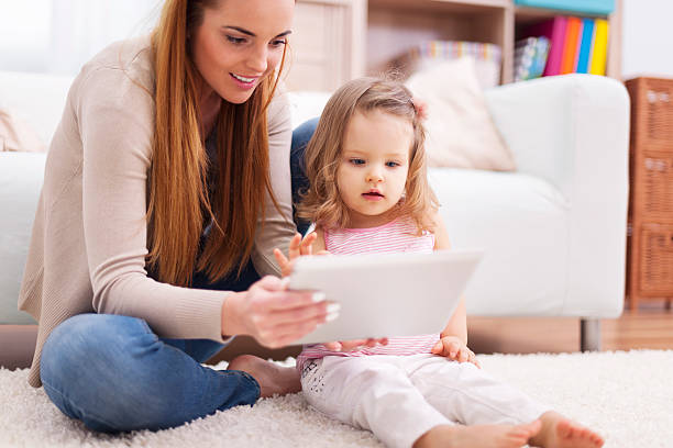istock Focus woman with little girl using digital tablet 484469863