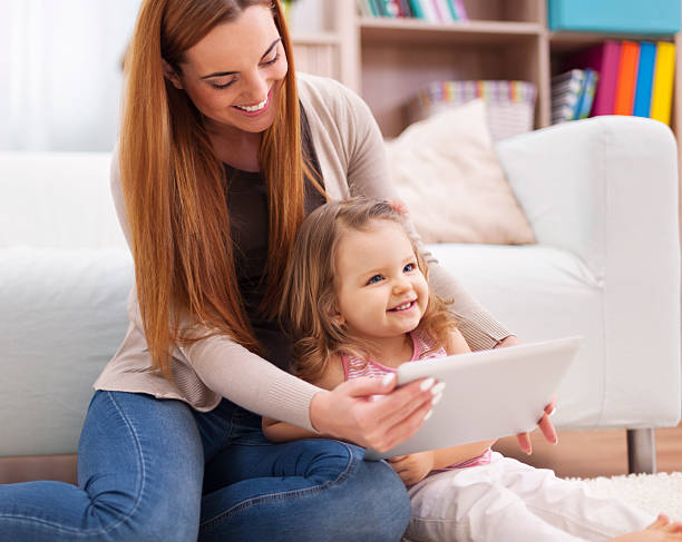 istock Mother and daughter have fun during the using digital tablet 484469865