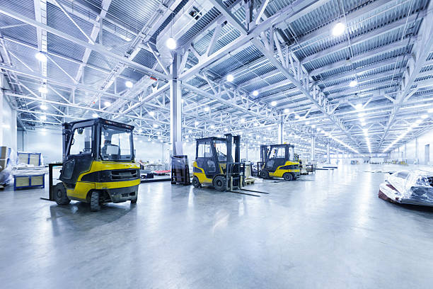 warehouse filled with forklifts