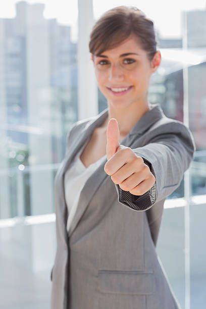 istock Smiling businesswoman giving thumb up 484470897
