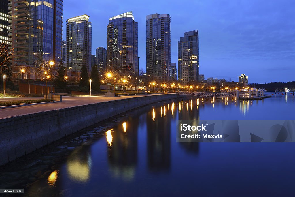 Coal Harbor Towers, Twilight, Vancouver Condominiums at twilight reflect in the calm water of Coal Harbor in downtown Vancouver. British Columbia, Canada. Apartment Stock Photo