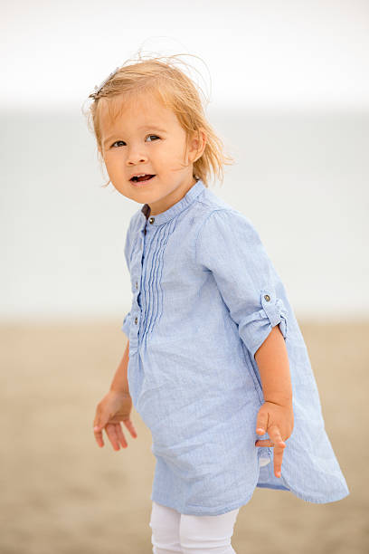 istock Little blond girl playing on the beach 484472068