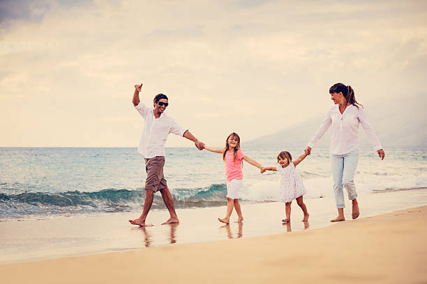 istock Happy Family have Fun Walking on Beach at Sunset 484472201