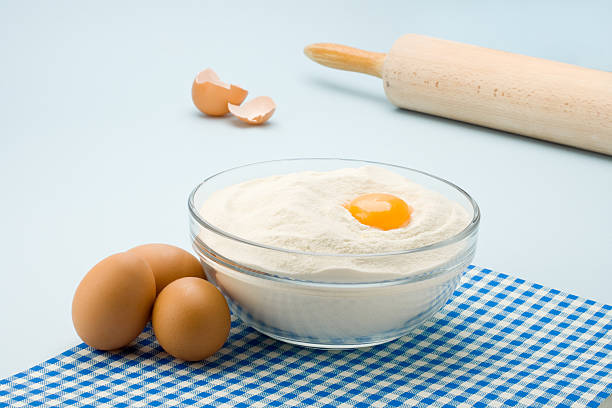 dough egg on flour stock photo