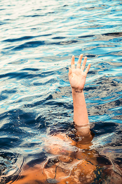 istock Drowning in water with word weak written on wrist. 484472717