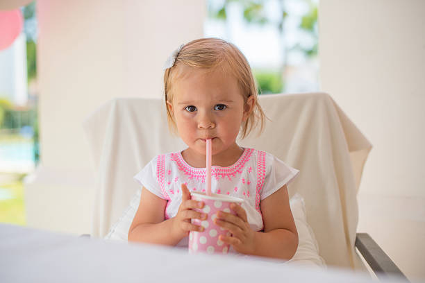 istock Little Toddler Drinking Juice From Paper Cup 484472820