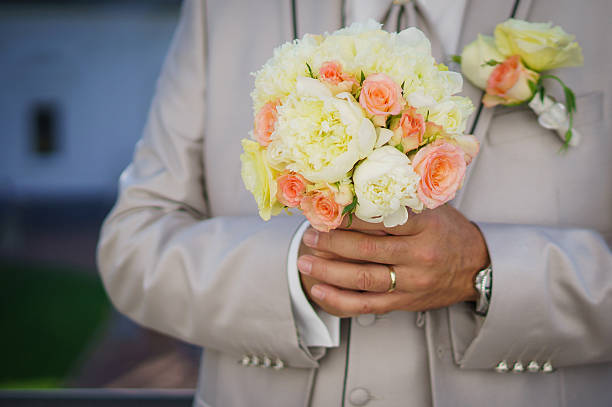 istock Groom with wedding bouquet 484472869