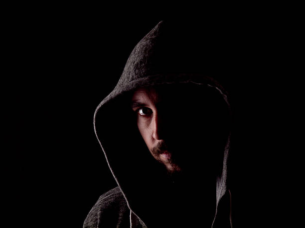 Low key image of a bearded man with hoody stock photo