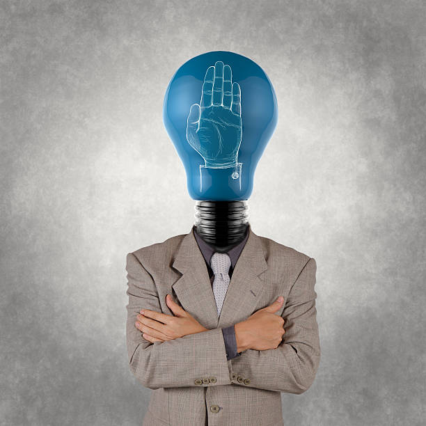istock businessman with lamp-head  and hand rised sign as concept 484475377