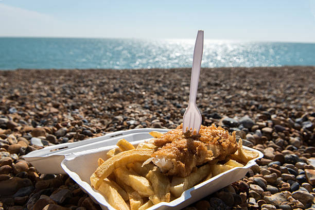 Fish and Chips by the sea Delicious fish and Chips take away meal enjoyed on the beach east sussex photos stock pictures, royalty-free photos & images