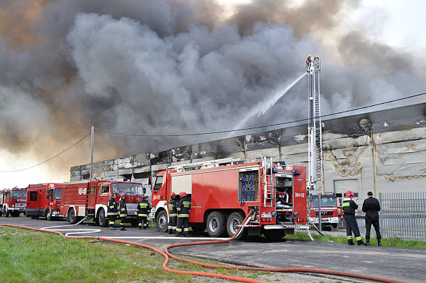 Firefighter crews battling storehouse fire stock photo