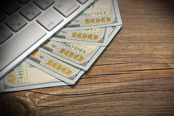 Computer Keyboard  And Dollar Cash On The Rough Wood Background. E-commerce Or Freelance Work Concept