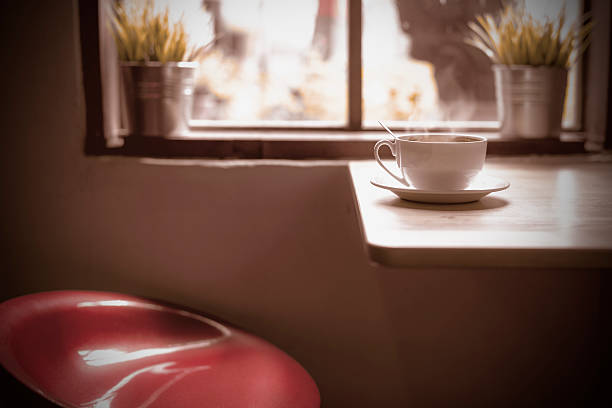 istock Hot coffee on table and red chair. 484487884