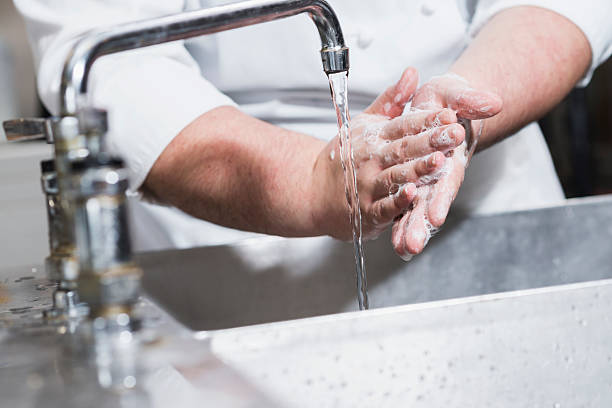 istock Worker in restaurant washing hands in kitchen sink 484488072