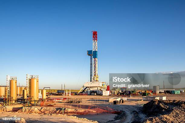 Fracking Fracking Drill Rig On The Prairie At Dusk Stock Photo - Download Image Now - Fracking, Drilling Rig, Offshore Platform