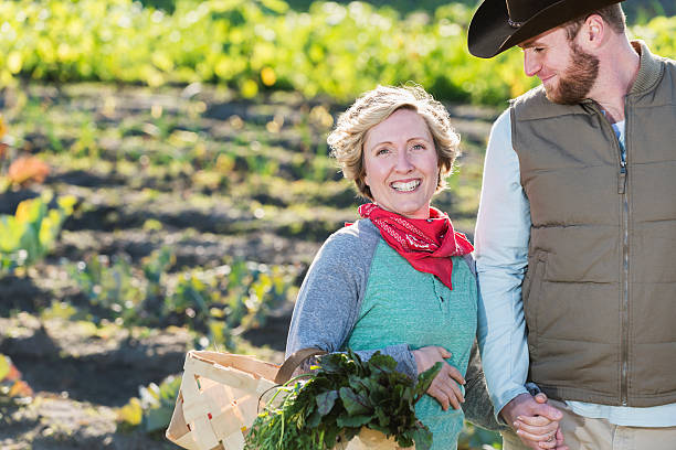 istock Affectionate couple on farm, smiling at the camera 484491514