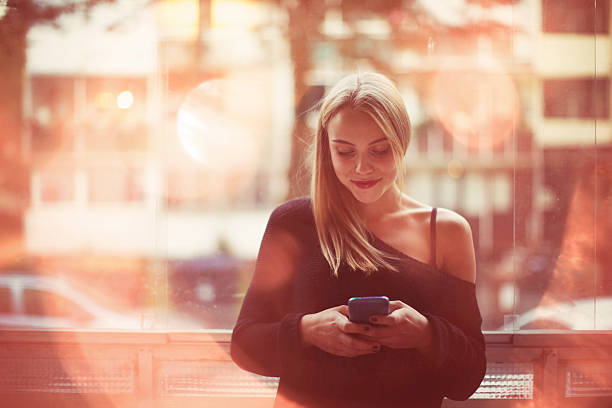 istock Young woman daydreaming and text messaging 484494440