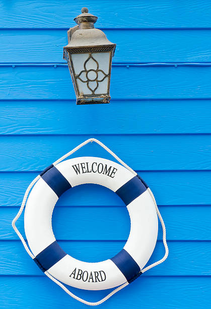 istock Life buoy welcome aboard sign and old lamp 484499918