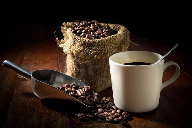 istock coffee beans in scoop with cup and gunny sack. 484506832