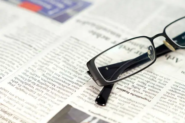 A newspaper and glasses