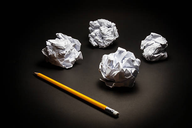 Pencil, crumpled paper on black background. Business frustrations, Job stress and Failed exam concept.