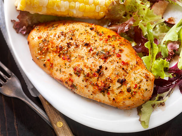 Oven Roasted Chicken Breast with Mixed Greens and Corn Oven Roasted Chicken Breast with Mixed Greens and Corn -Photographed on Hasselblad H3D2-39mb Camera Baked Chicken Breast stock pictures, royalty-free photos & images