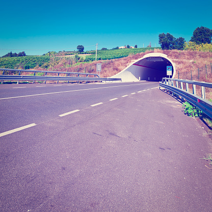 Tunnel under the Vineyard on the Asphalt Road  in Tuscany, Italy, Retro Effect