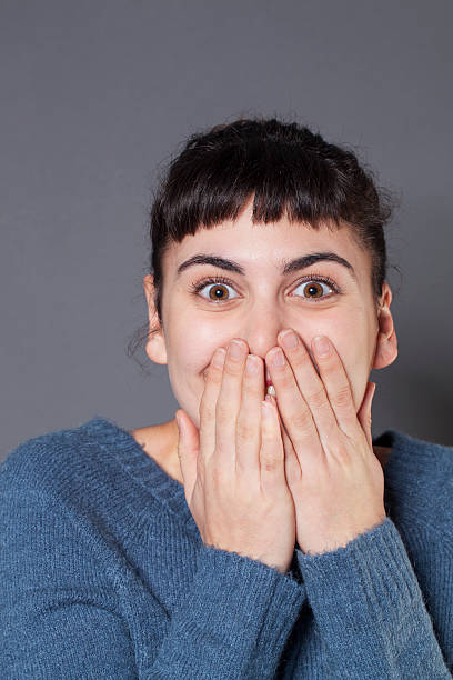 istock cheerful brunette smiling with shyness 484512308