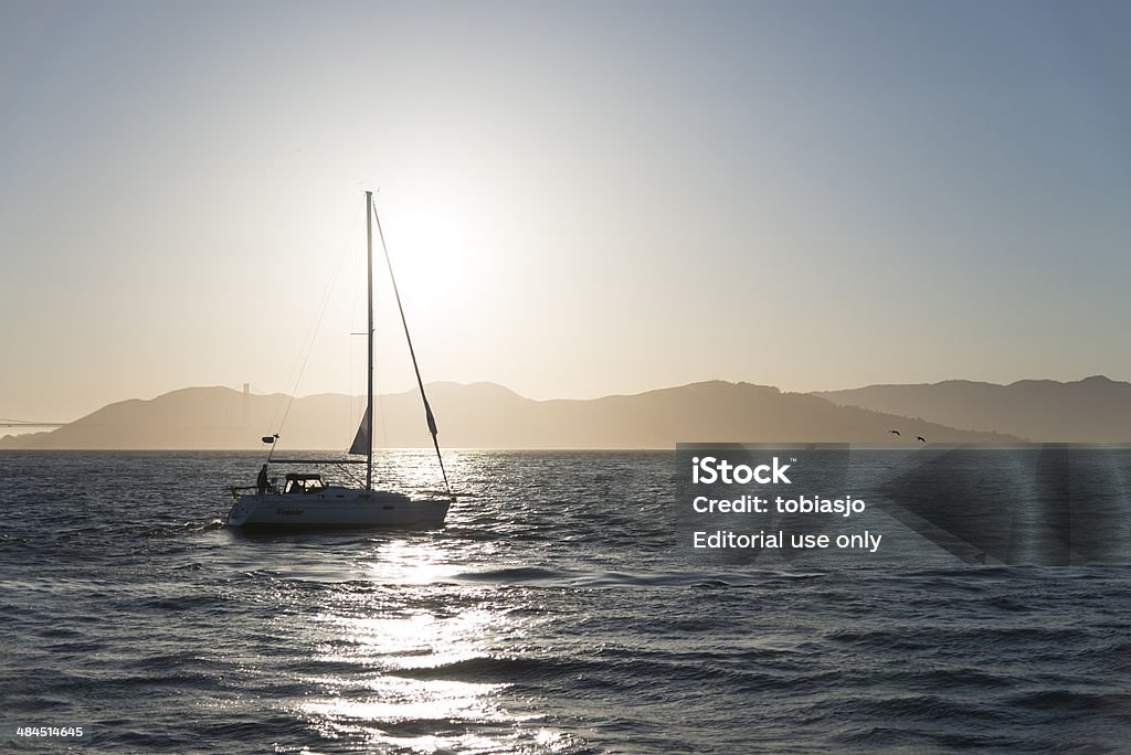 Sailboat in San Francisco San Francisco, California, USA - May 19, 2013: View at Sailboat in the San Francisco bay area during sunset. Bay of Water Stock Photo