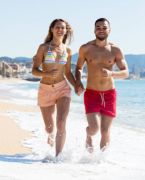 istock family running on the shore 484514686