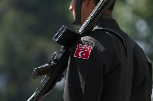 Istanbul, Turkey - May 7, 2010: Turkish soldier in helmet and uniform stands at attention with rifle. The army has played a pivotal role in the stability of modern secular Turkey, the only Muslim member of NATO and a political bridge between the West and the Middle East.