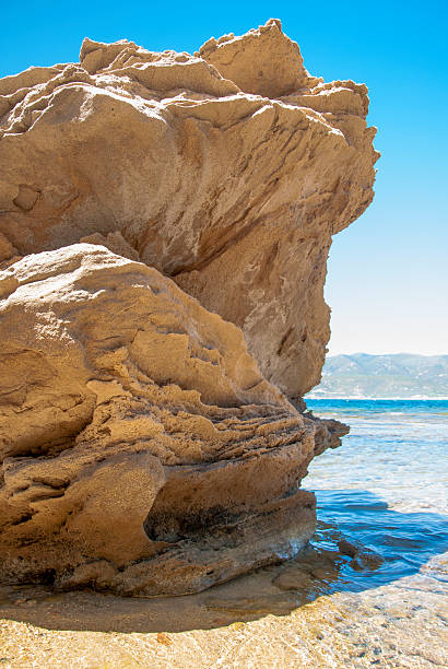 istock Rock in the seashore with clear blue sky seen, right 484514850