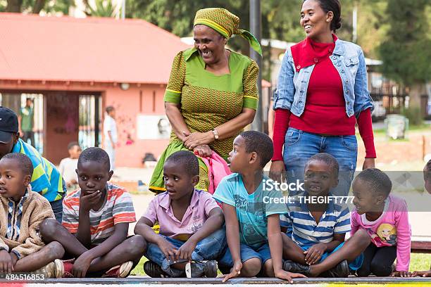 Children Sitting Down Watching The Skateboarders Stock Photo - Download Image Now - Africa, African Culture, African Ethnicity
