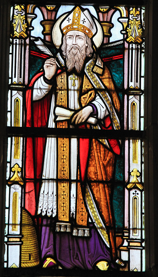 Stained glass window depicting Saint Ambrose or Ambrosius, in the Church of Stabroek, Belgium.