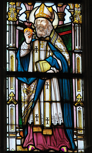 Stained glass window depicting Saint Augustine in the Church of Stabroek, Belgium.