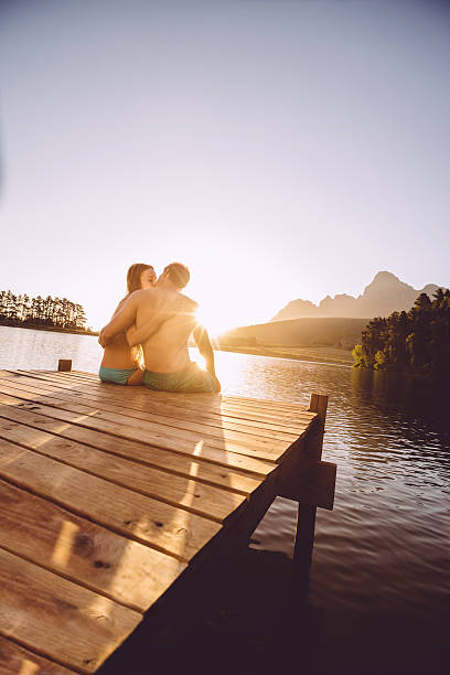 istock Kissing couple by the lake 484518569