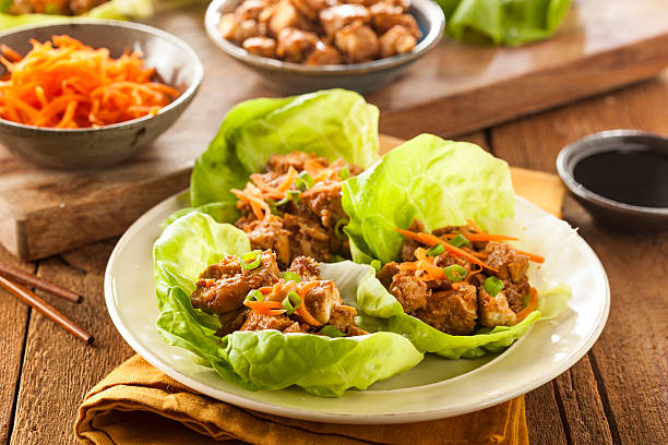 Healthy Asian Chicken Lettuce Wrap Healthy Asian Chicken Lettuce Wrap with Carrots wrap sandwich photos stock pictures, royalty-free photos & images