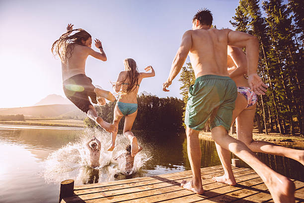 istock Jumping into the water from a jetty 484519127