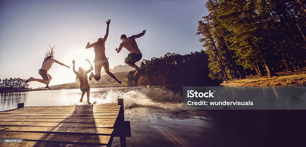 Jumping into the water from a jetty Lake Stock Photo