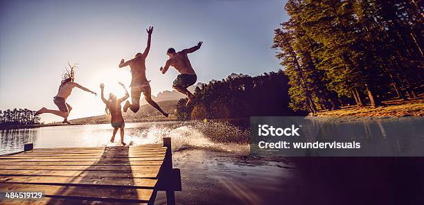 Jumping Into The Water From A Jetty Stock Photo - Download Image Now - Lake, Summer, Jumping