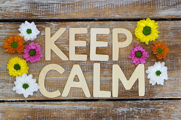 istock Keep calm written with wooden letters and Santini flowers 484525866