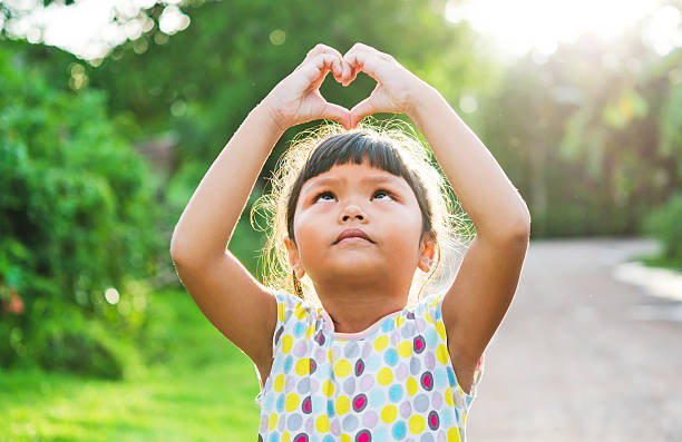 istock children look pass hand heart 484525896